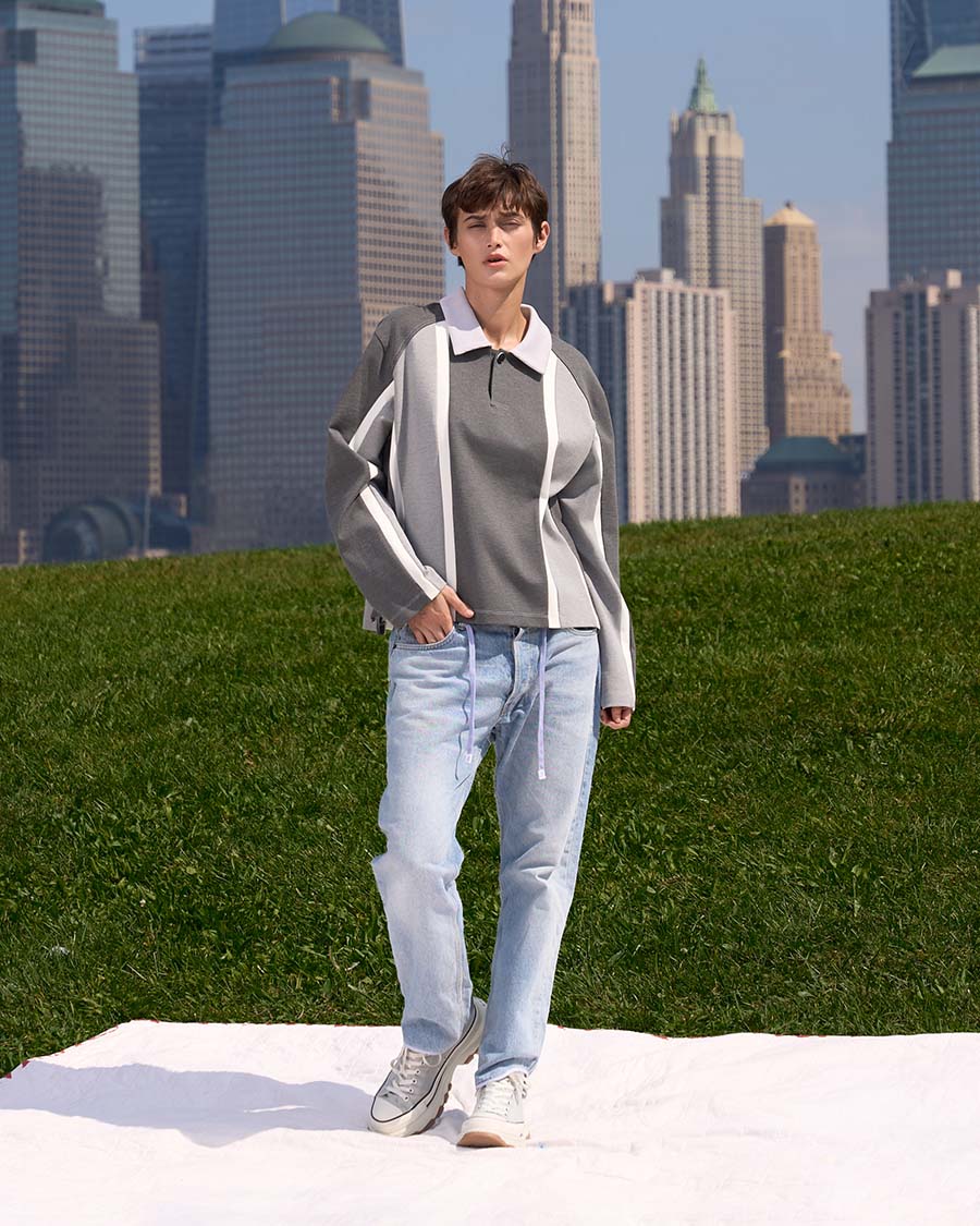 Brando Vassallo Editorial Fashion Lookbook Girl grey striped rugby shirt with jeans. city skyline in background